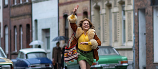 A woman is walking down a street.