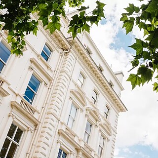 Photo of the building outside, made from under a tree