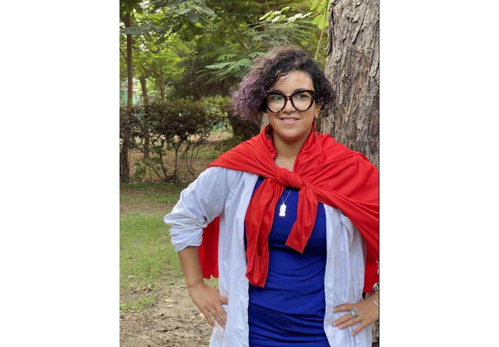  سيدة تبتسم ترتدي نظارة طبية و معطف أحمر