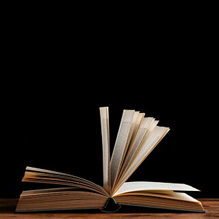 Photo of an open book laying on a table