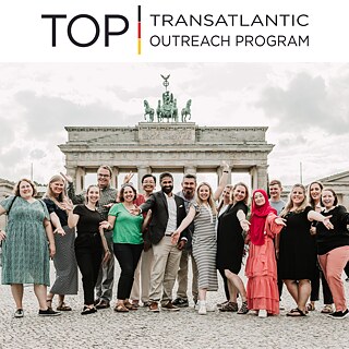 A TOP study tour group poses in front of the Brandenburg Gate in Berlin, Germany.