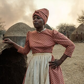 Eine schwarze Frau in einem roten Kleid.