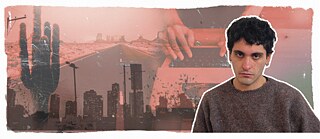 Porträtfoto von Mücahit Türk vor blauem Hintergrund, im Hintergrund sind eine Straße und Gebäude zu sehen. 