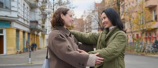 two friends are hugging