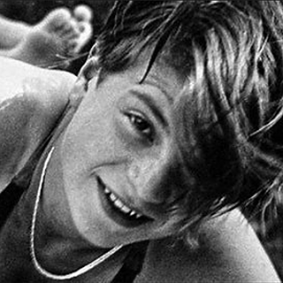 A black and white picture of Sophie Scholl wearing a swimsuit and smiling into the camera