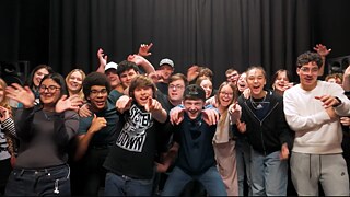 A group of young people look into the camera