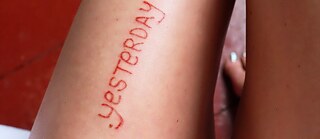 Leg with the word Yesterday as a tattoo