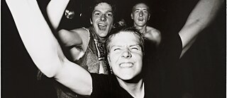 Three people partying at a concert.