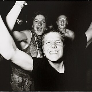 Three people partying at a concert.