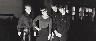 Members of the band NO MORE in front of a building