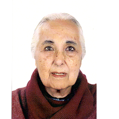 Head shot of Romila Thapar in front of a white backgrond, she has white hair and wears a wine-red turtleneck
