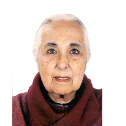 Head shot of Romila Thapar in front of a white backgrond, she has white hair and wears a wine-red turtleneck