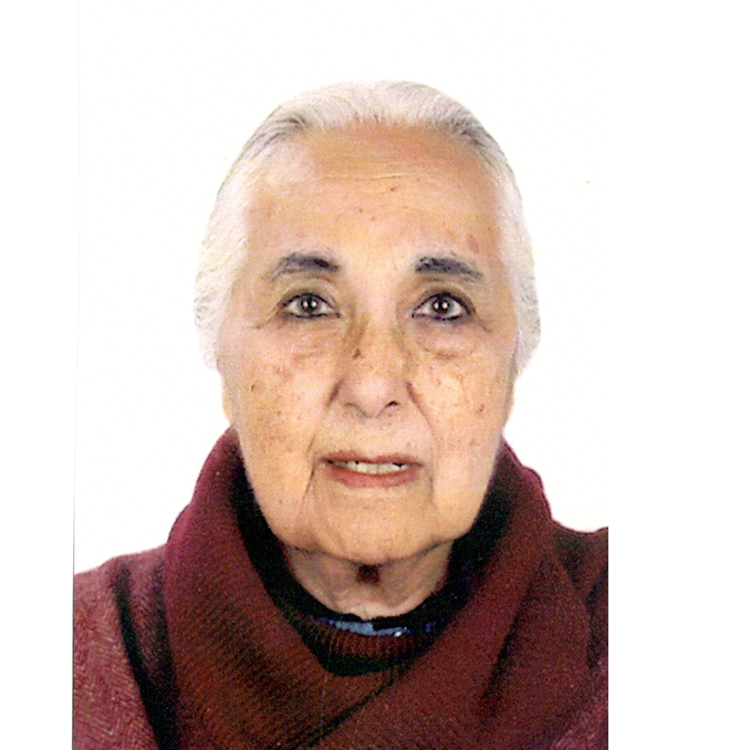 Head shot of Romila Thapar in front of a white backgrond, she has white hair and wears a wine-red turtleneck