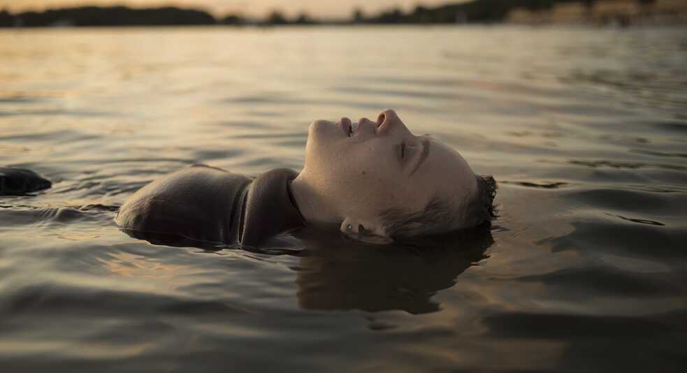  Esty floating on her back in the lake