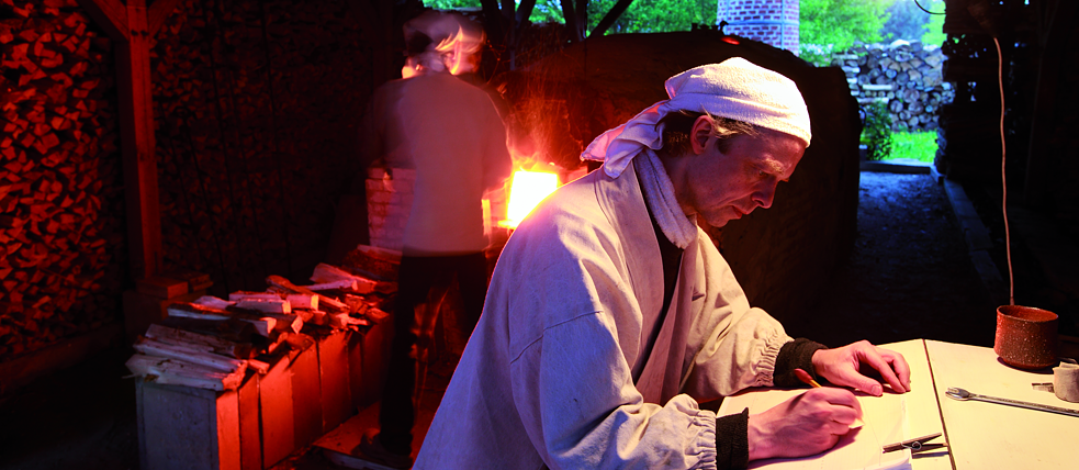Jan Kollwitz and a friend and helper take turns feeding wood to the fire every three minutes.